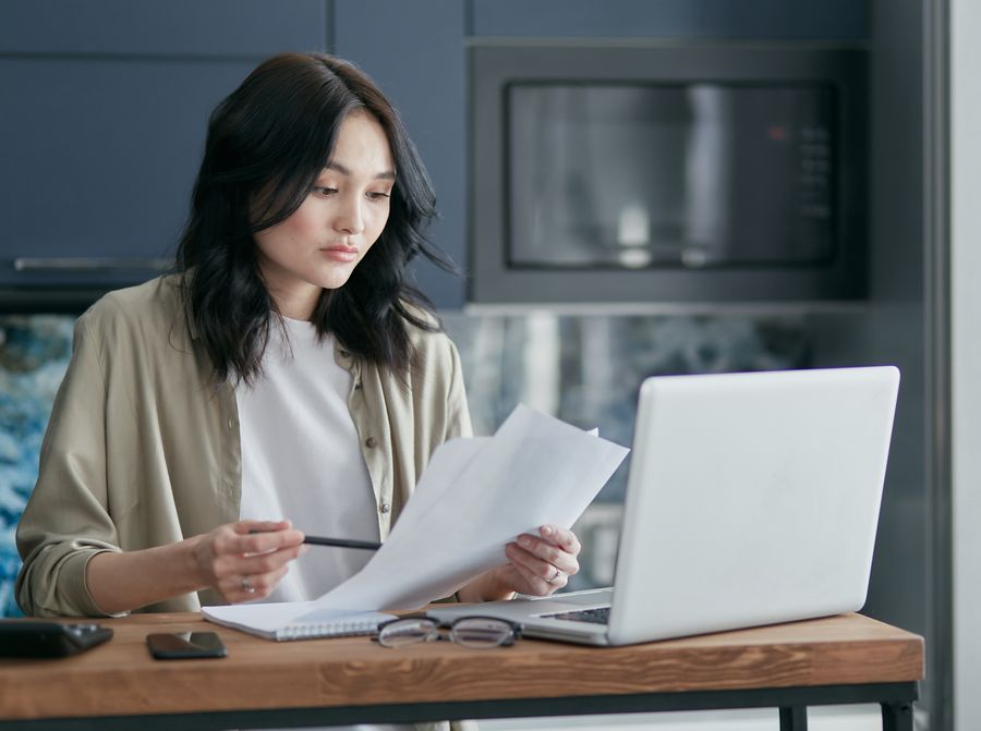 person reading legal document laptop