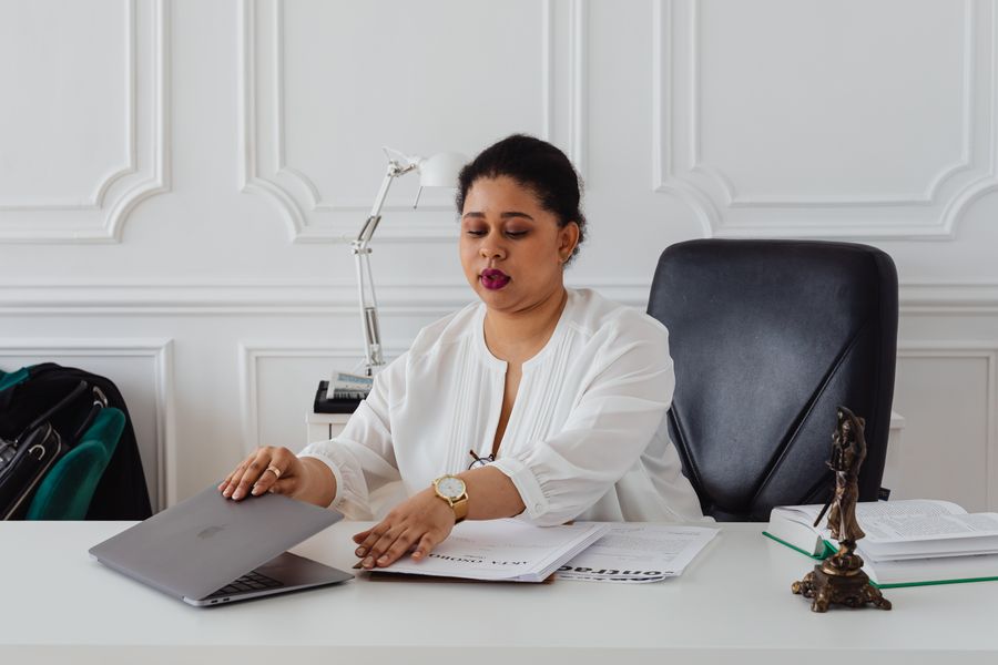 person reading legal document laptop